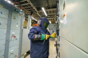OQ Chemical employee works beneath Dialight SafeSite LED Linears in the electrical load room.